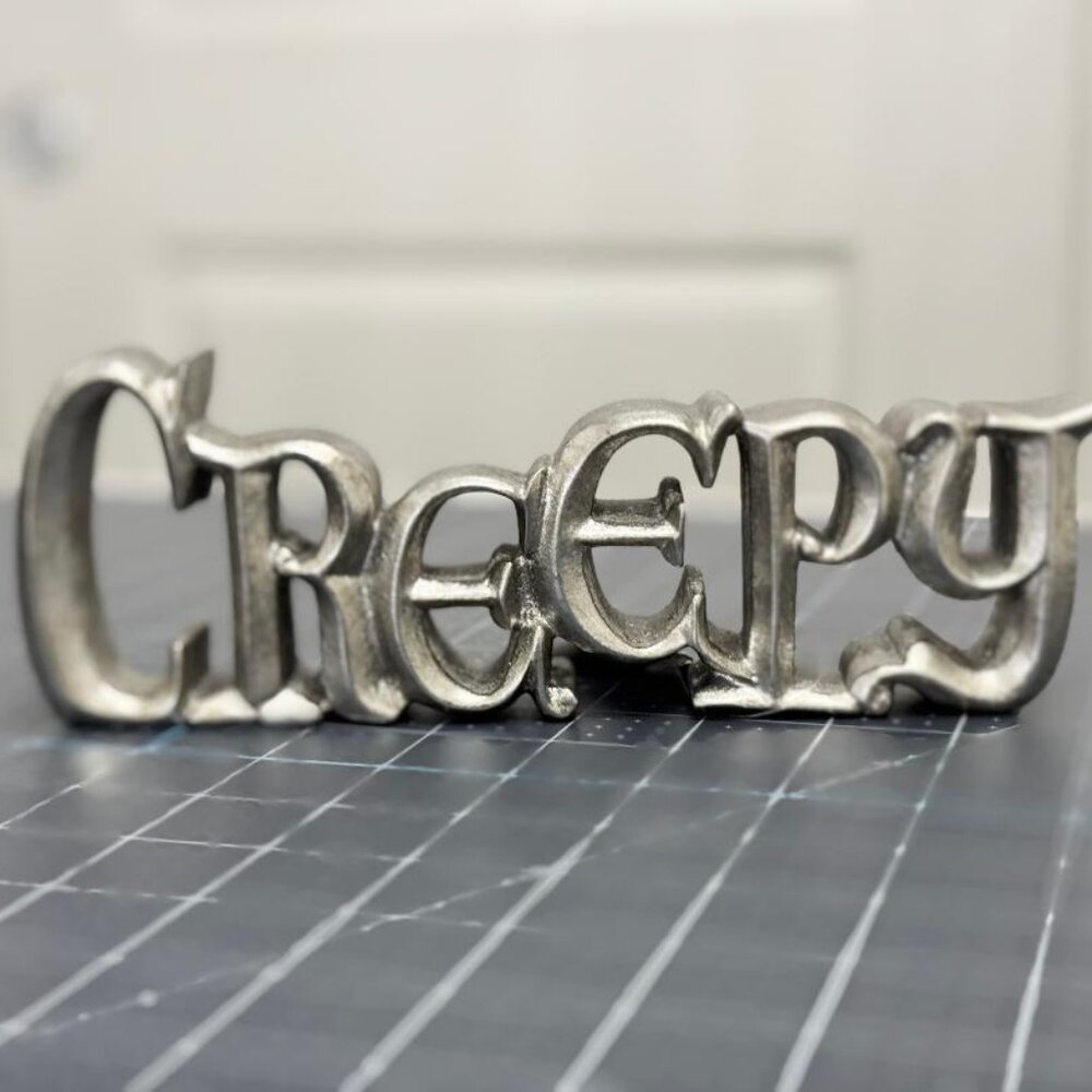 Silver Metal CREEPY Cutout Tabletop Sign by Makers Halloween